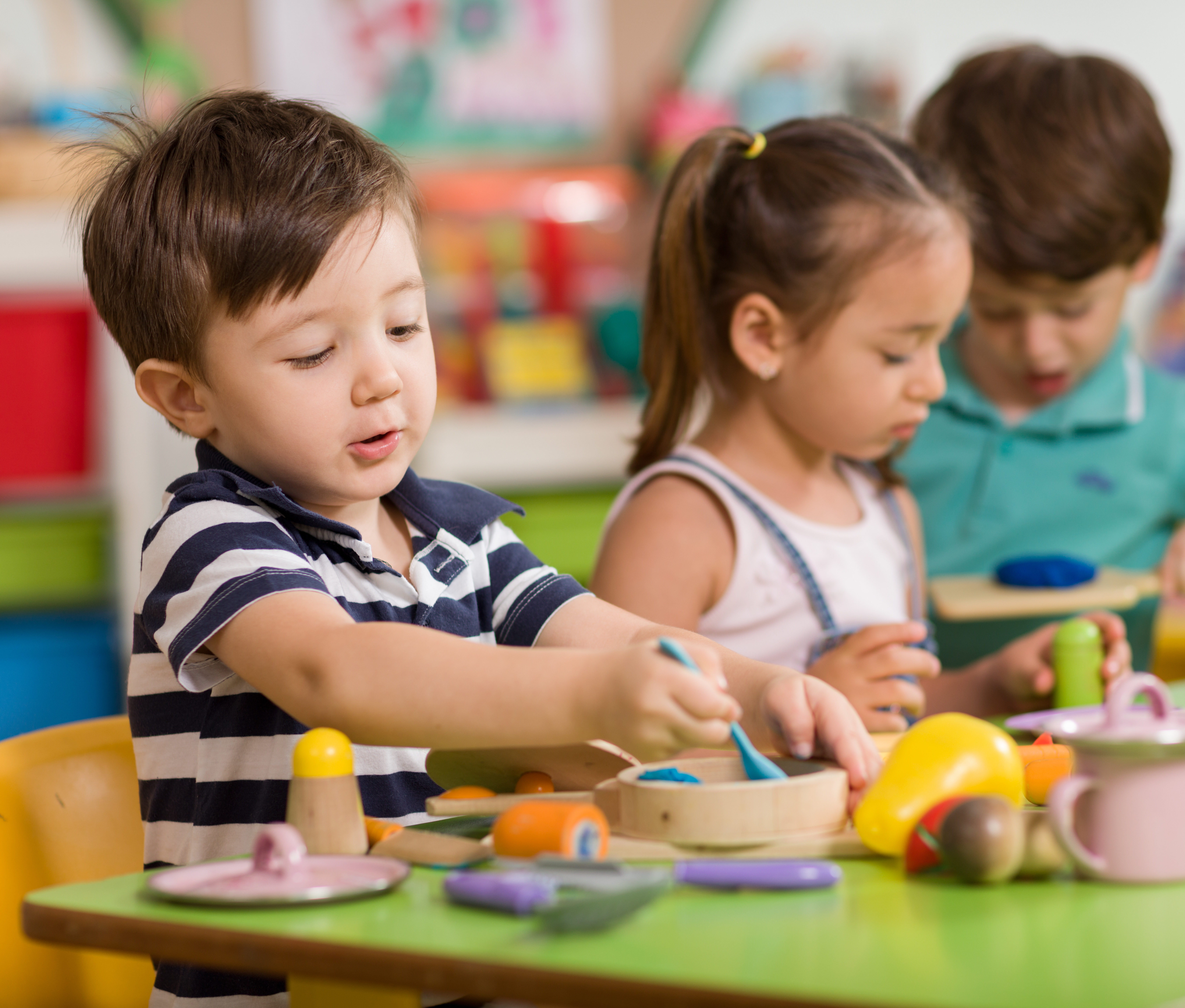 Children pretending to cook with toys