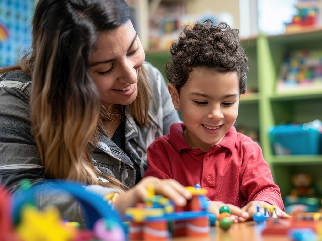 Child and teacher playing with toys in class